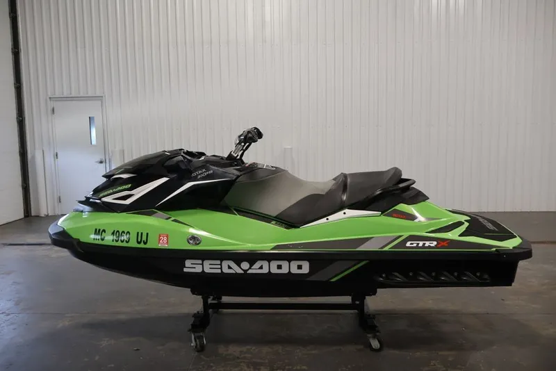 Slide: The Image of 2018 Sea-Doo GTR-X 230 jet ski in a garage, vibrant green and black design. - 9