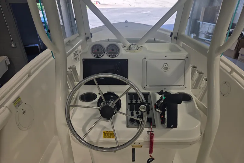 Slide: The Image of 2007 Everglades 211 Center Console boat dashboard with steering wheel and controls. - 4