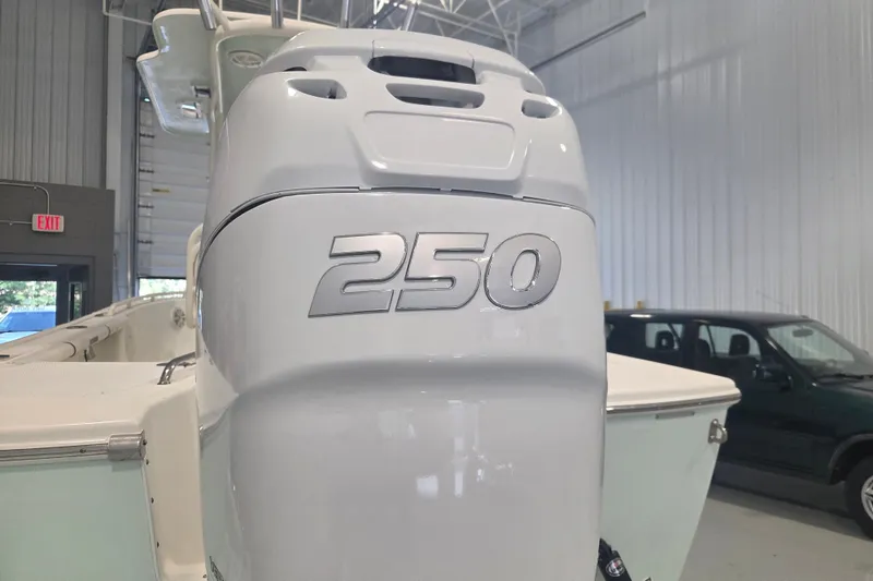 Slide: The Image of 2007 Everglades 211 Center Console boat with 250 horsepower engine in a garage setting. - 3