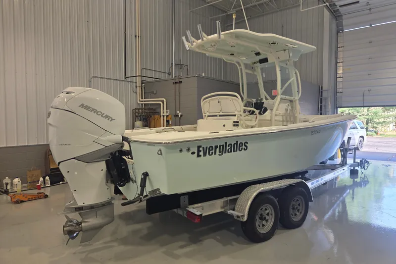 Slide: The Image of 2007 Everglades 211 Center Console boat on trailer in garage with Mercury engine. - 2