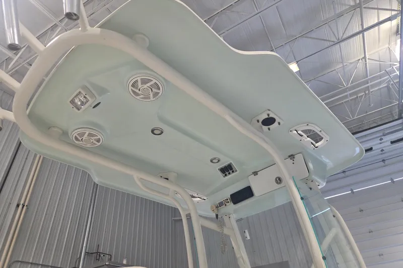 Slide: The Image of 2007 Everglades 211 Center Console boat's overhead view with speakers and lighting in a garage. - 14