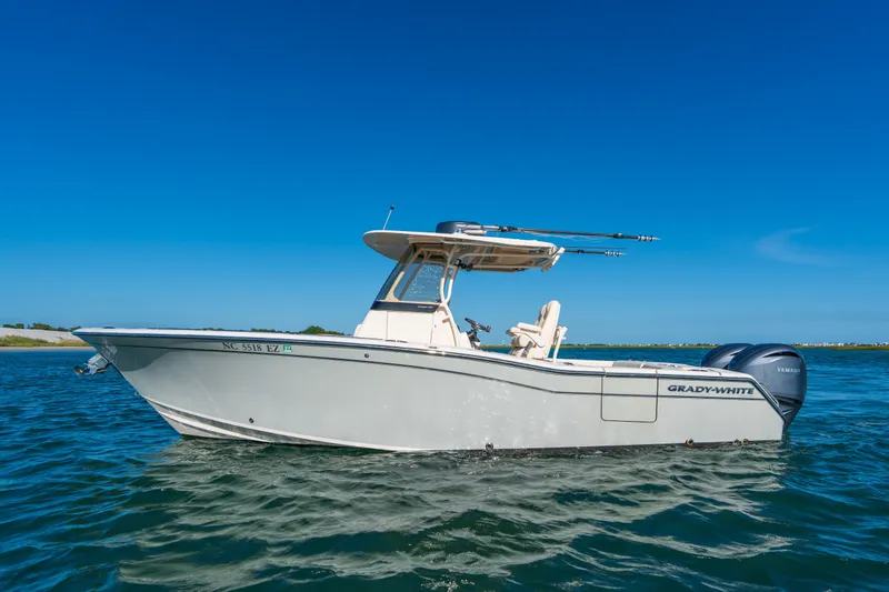Slide: The Image of 2023 Grady-White Canyon 271 FS boat on clear blue water. - 1