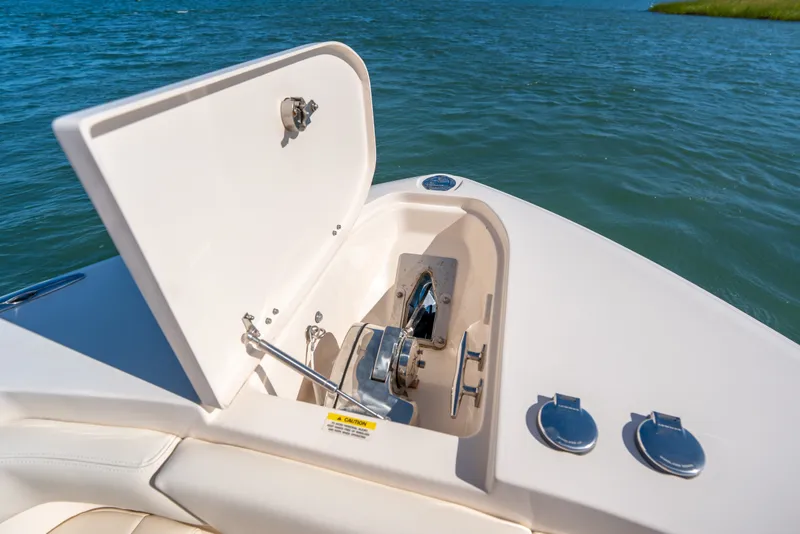 Slide: The Image of 2023 Grady-White Canyon 271 FS boat anchor compartment open on calm water. - 9