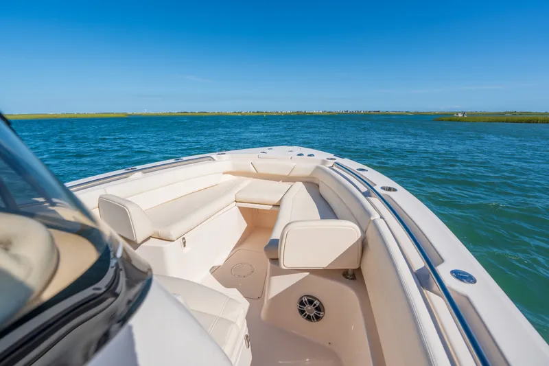 Slide: The Image of 2023 Grady-White Canyon 271 FS boat on open water, featuring spacious seating. - 8