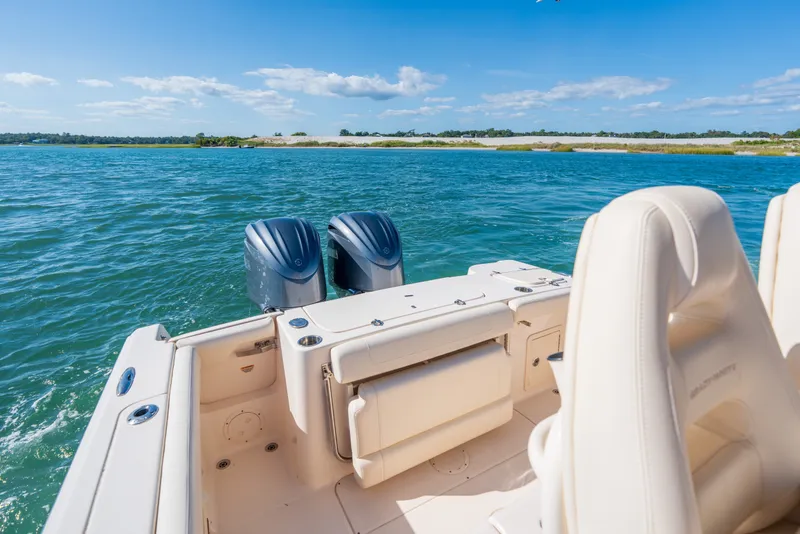 Slide: The Image of 2023 Grady-White Canyon 271 FS boat on water, featuring dual engines and comfortable seating. - 17