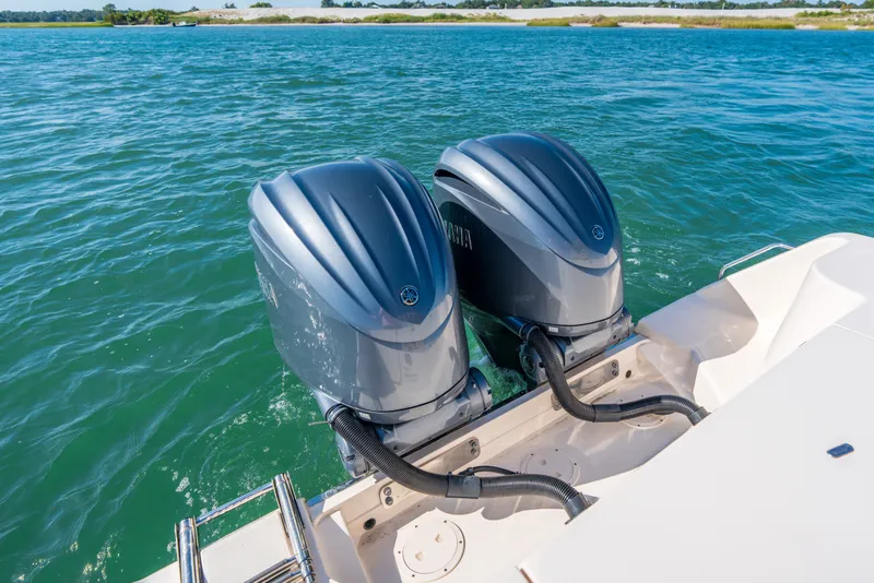 Slide: The Image of 2023 Grady-White Canyon 271 FS with dual Yamaha outboard motors on water. - 19