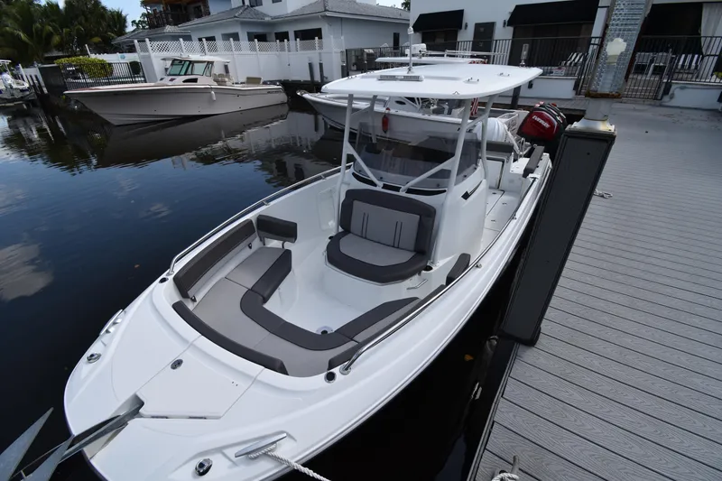 Slide: The Image of 2022 Jeanneau 7.5 Leader boat docked at a marina. - 0