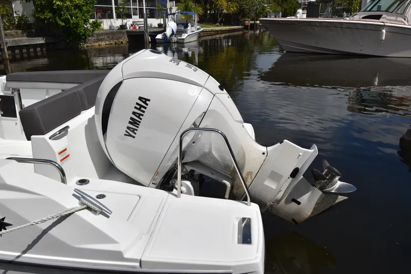 Slide: The Image of 2022 Jeanneau 7.5 Leader with Yamaha outboard motor docked in a marina. - 19