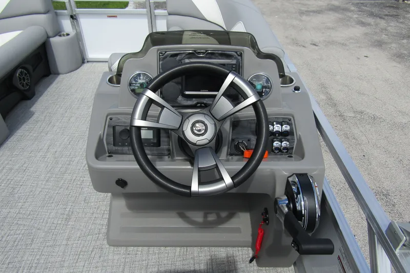 Slide: The Image of 2026 Tahoe Pontoon Sport 85 Versatile Rear Bench steering console with modern controls. - 17