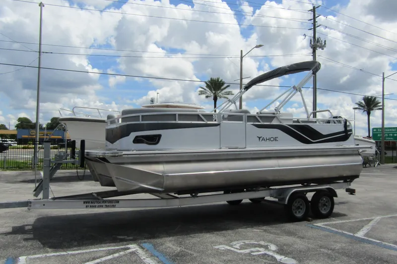 Slide: The Image of 2026 Tahoe Pontoon Sport 85 Versatile Rear Bench on trailer, parked outdoors. - 5