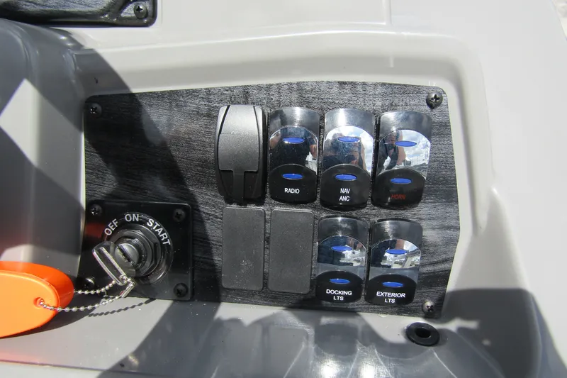 Slide: The Image of Control panel of 2026 Tahoe Pontoon Sport 85 Versatile Rear Bench with switches and ignition. - 22