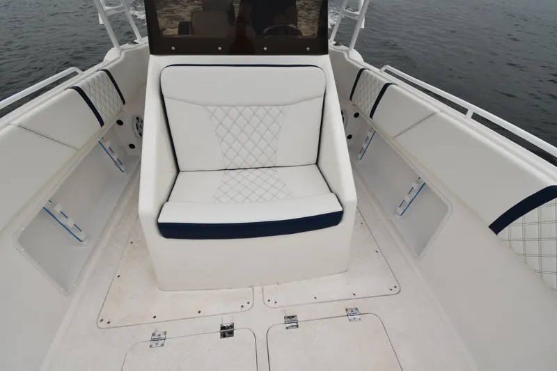 Slide: The Image of 1984 Chris-Craft Scorpion boat interior with white cushioned seating. - 9