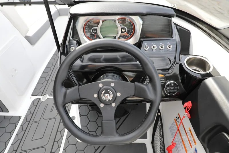 Slide: The Image of 2023 Scarab 195 ID boat dashboard with steering wheel and control panel. - 6