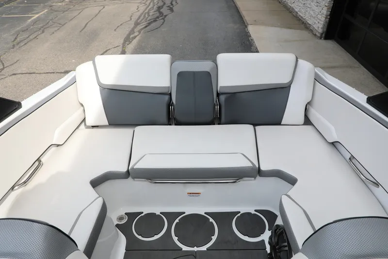 Slide: The Image of Interior seating of 2023 Scarab 195 ID boat, featuring sleek white and gray upholstery. - 7