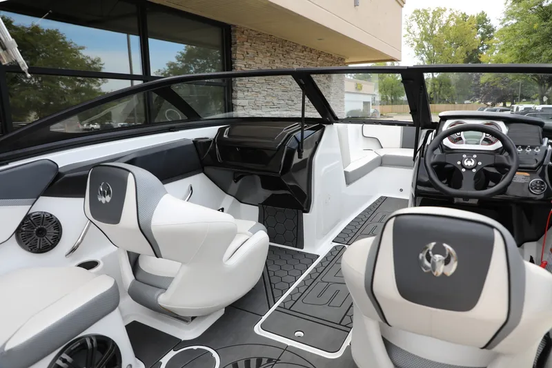 Slide: The Image of 2023 Scarab 195 ID boat interior with modern seating and sleek dashboard design. - 9