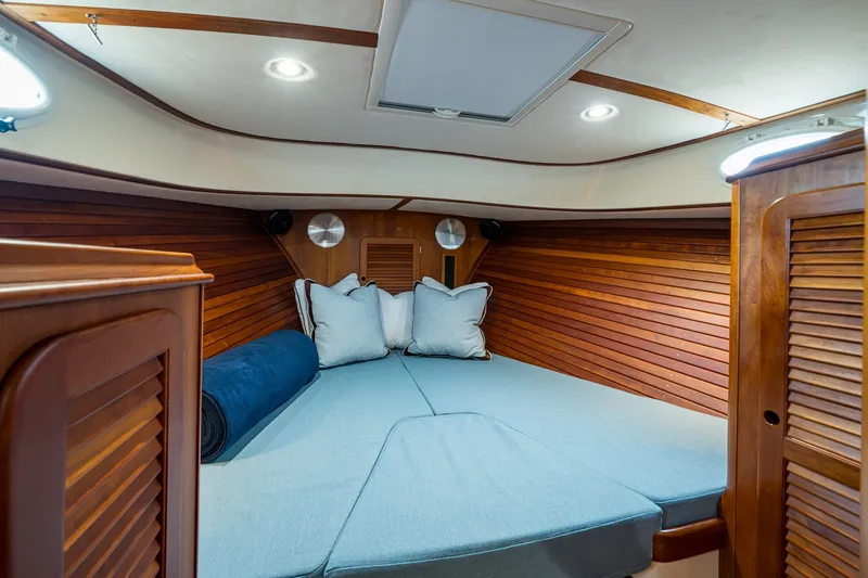 Slide: The Image of Cozy cabin interior of 2009 Hinckley Picnic Boat 37 MKIII with wood paneling and cushions. - 21