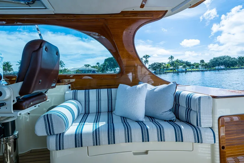Slide: The Image of Luxurious interior of 2009 Hinckley Picnic Boat 37 MKIII with striped seating and scenic water view. - 13