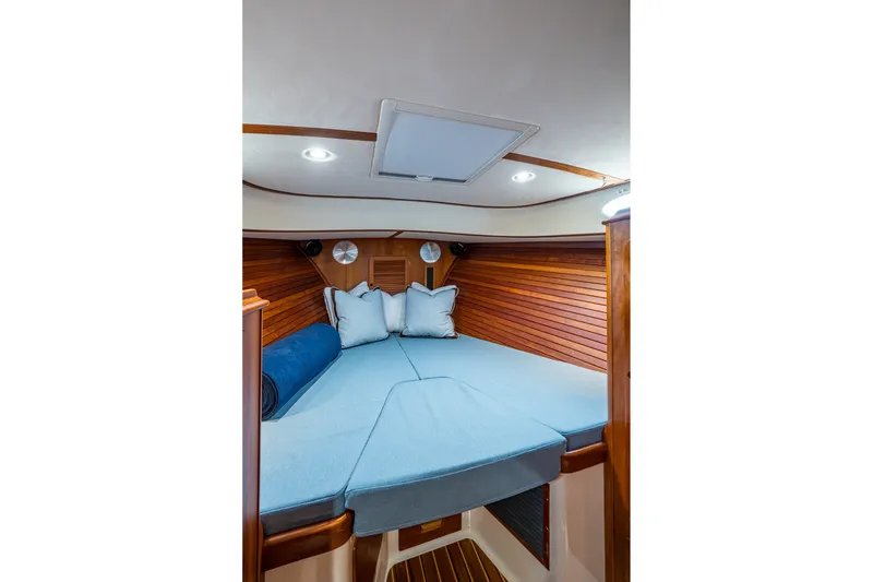 Slide: The Image of Cozy cabin interior of 2009 Hinckley Picnic Boat 37 MKIII with blue bedding and wood paneling. - 22
