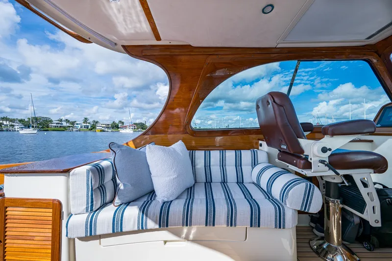 Slide: The Image of Interior of 2009 Hinckley Picnic Boat 37 MKIII with striped seating and scenic water view. - 12