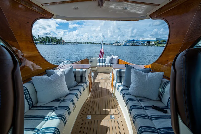 Slide: The Image of Luxurious interior of 2009 Hinckley Picnic Boat 37 MKIII with striped seating and scenic water view. - 11