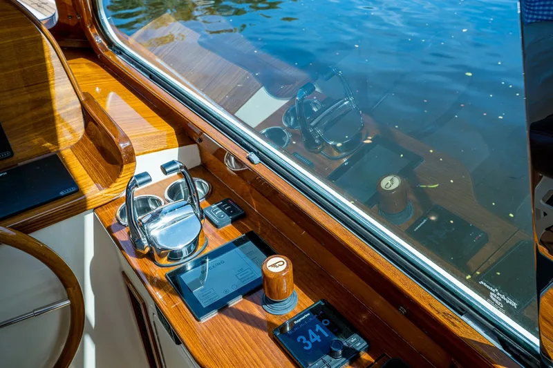 Slide: The Image of Helm of 2009 Hinckley Picnic Boat 37 MKIII with polished wood and modern controls. - 17