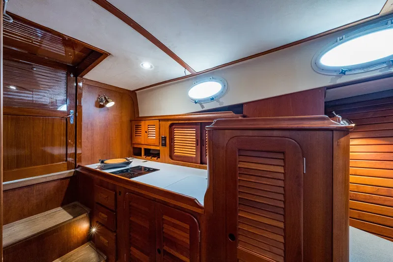 Slide: The Image of Interior of 2009 Hinckley Picnic Boat 37 MKIII with wooden cabinetry and modern amenities. - 19