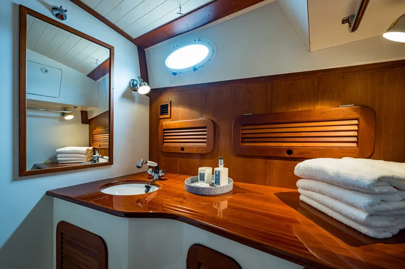 Slide: The Image of Luxurious wooden bathroom interior of 2009 Hinckley Picnic Boat 37 MKIII with mirror and towels. - 24