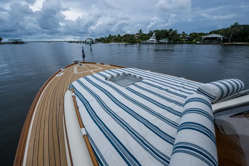 Slide: The Image of Hinckley Picnic Boat 37 MKIII, 2009, with striped deck cushions on calm waters. - 8