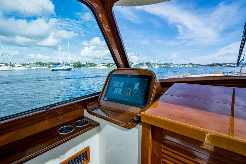 Slide: The Image of Interior view of 2009 Hinckley Picnic Boat 37 MKIII with navigation screen and ocean backdrop. - 14