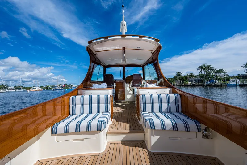 Slide: The Image of Hinckley Picnic Boat 37 MKIII, 2009, with striped seating, on a sunny waterfront. - 10