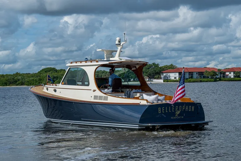 Slide: The Image of 2009 Hinckley Picnic Boat 37 MKIII cruising on a calm waterway under cloudy skies. - 2