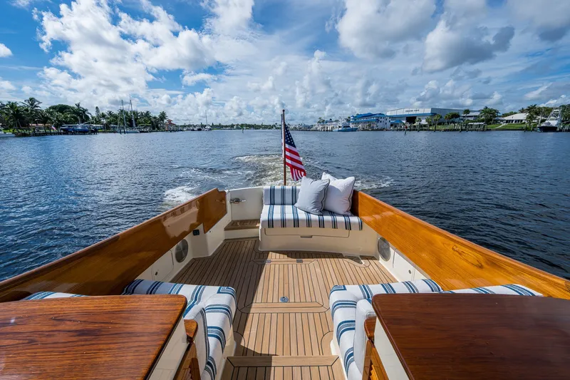 Slide: The Image of Hinckley Picnic Boat 37 MKIII, 2009, cruising on a sunny day with striped seating and American flag. - 9