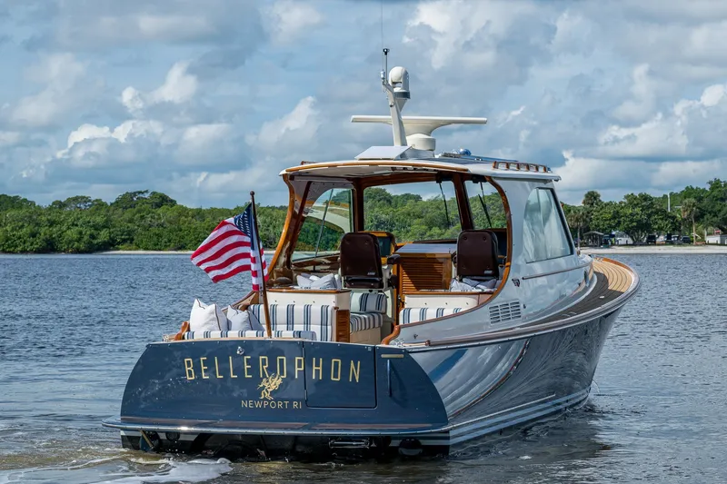 Slide: The Image of Hinckley Picnic Boat 37 MKIII, 2009, cruising on a calm waterway with American flag. - 0