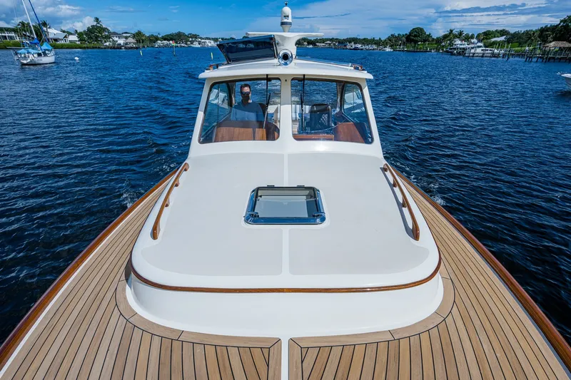Slide: The Image of 2009 Hinckley Picnic Boat 37 MKIII cruising on a serene waterway. - 7