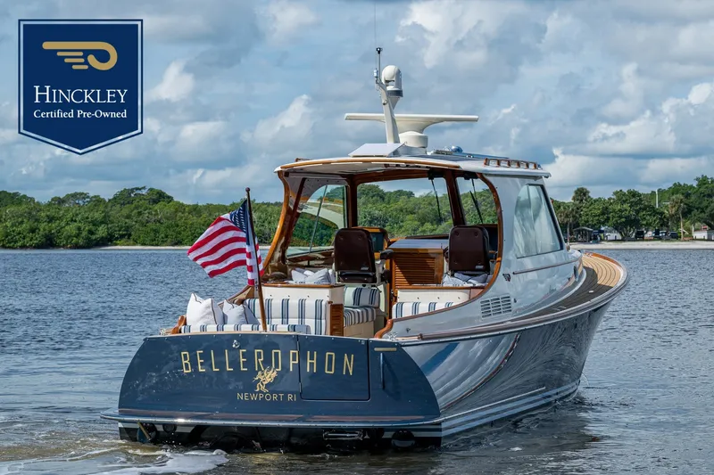Slide: The Image of 2009 Hinckley Picnic Boat 37 MKIII on calm water with an American flag. - 0