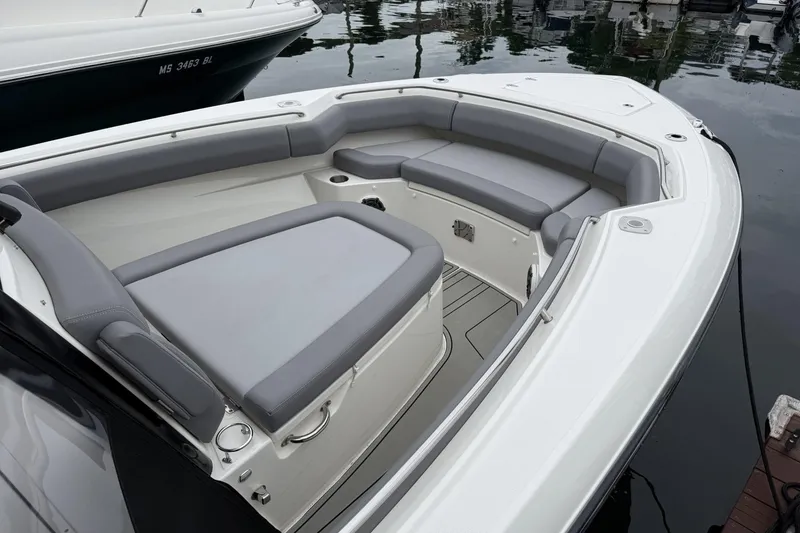 Slide: The Image of 2024 Boston Whaler 280 Outrage boat with spacious seating and sleek design. - 7