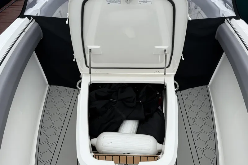Slide: The Image of Open storage compartment on 2024 Boston Whaler 280 Outrage boat, featuring hexagonal floor design. - 17