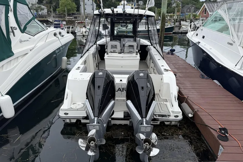 Slide: The Image of 2024 Boston Whaler 280 Outrage docked, featuring dual outboard engines. - 3