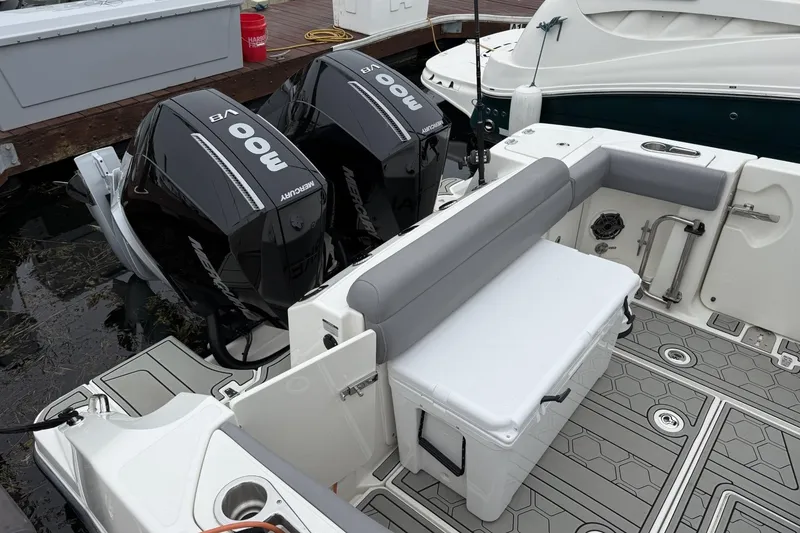 Slide: The Image of 2024 Boston Whaler 280 Outrage boat with dual Mercury outboard engines at dock. - 5
