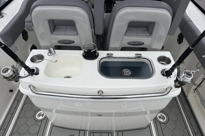 Slide: The Image of 2024 Boston Whaler 280 Outrage fishing station with rod holders and sink. - 10