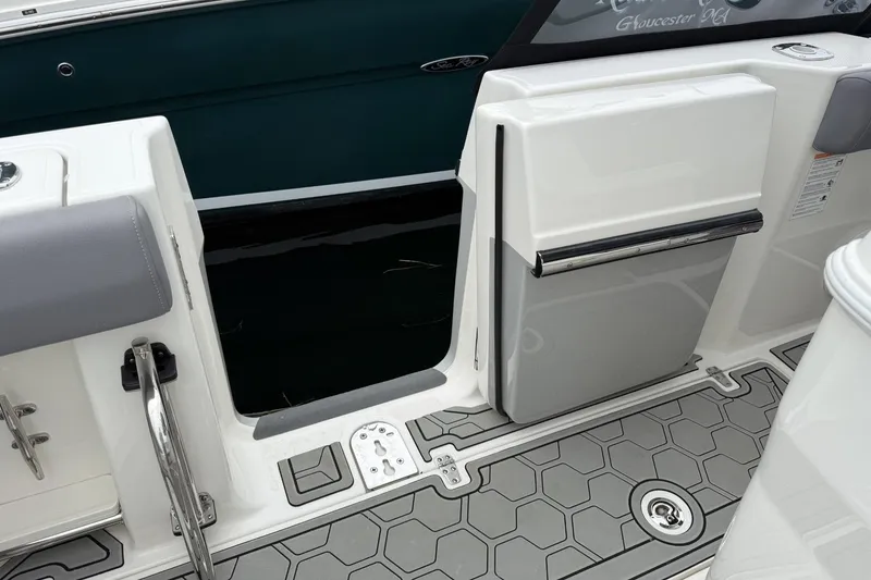 Slide: The Image of 2024 Boston Whaler 280 Outrage boat deck with open side door and gray flooring. - 11
