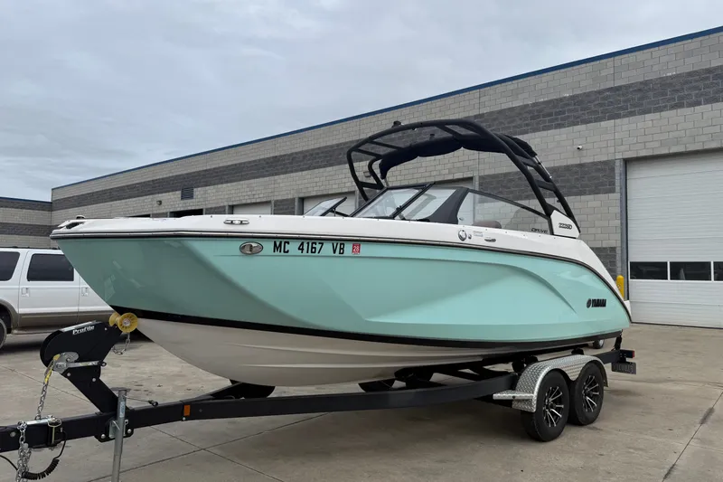 The Image of 2024 Yamaha Boats 222SD on trailer, parked outside industrial building. - 0