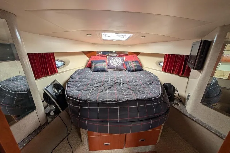 Slide: The Image of Interior cabin of a 2008 Formula 40 Performance Cruiser with cozy bedding and red curtains. - 25