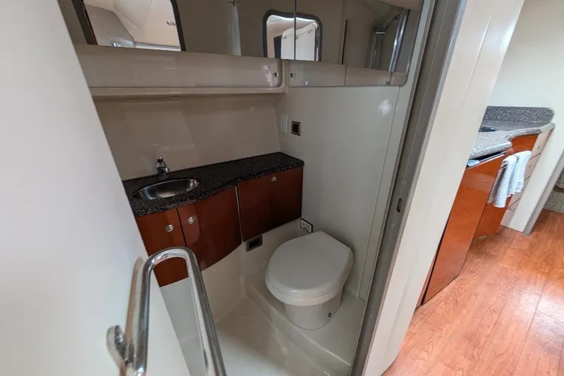 Slide: The Image of 2008 Formula 40 Performance Cruiser bathroom with sink, toilet, and wooden cabinetry. - 28