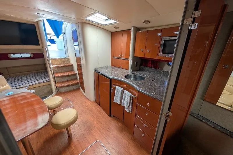 Slide: The Image of Interior of a 2008 Formula 40 Performance Cruiser with modern kitchen and cozy seating area. - 21