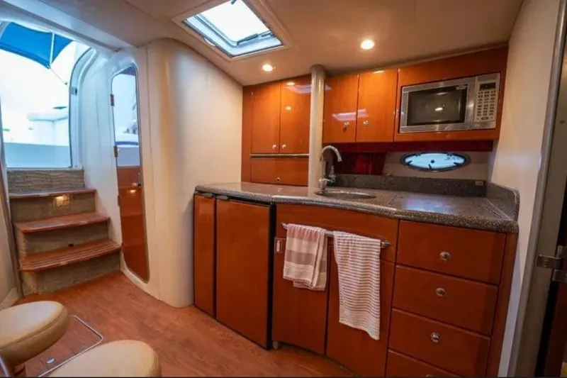 Slide: The Image of Interior of 2008 Formula 40 Performance Cruiser with modern kitchen and wooden cabinetry. - 23