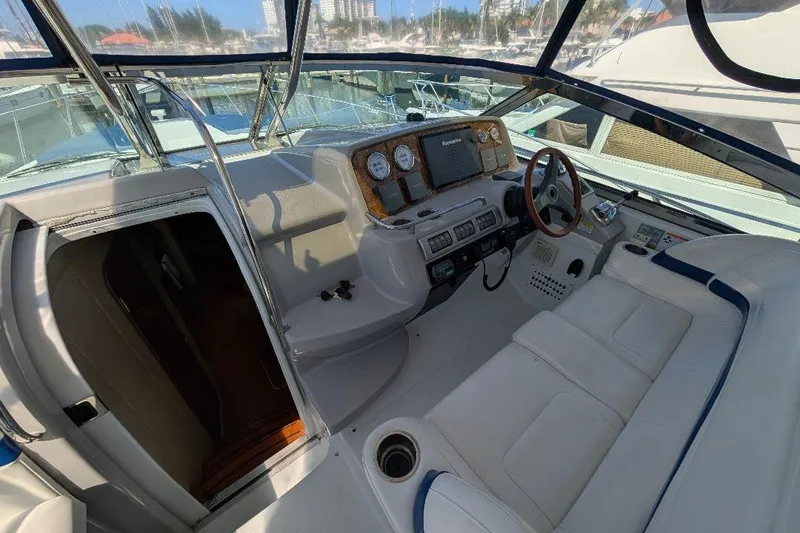 Slide: The Image of 2008 Formula 40 Performance Cruiser cockpit with white seating and control panel. - 13