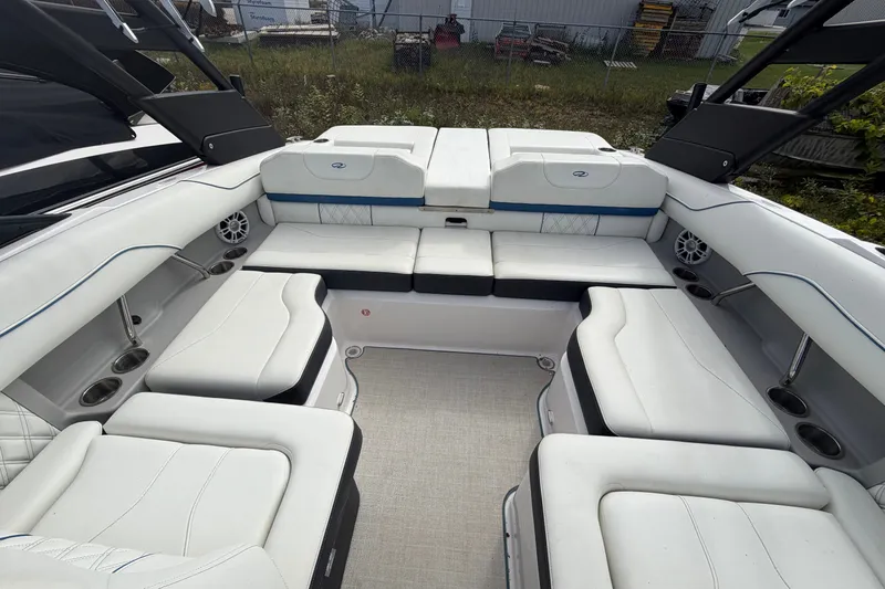 Slide: The Image of 2021 Regal LS2 Surf boat interior with white seating and cup holders. - 5