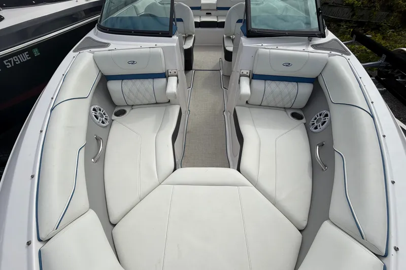 Slide: The Image of 2021 Regal LS2 Surf boat interior with white seating and blue accents. - 13