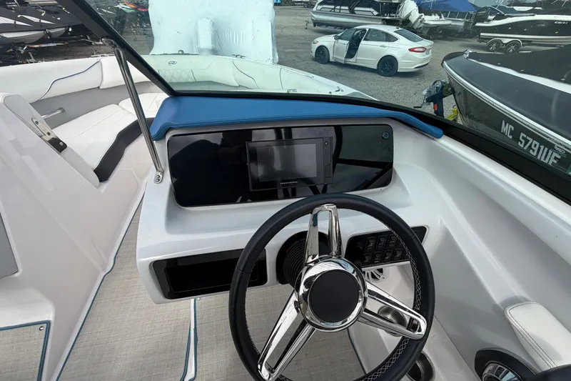Slide: The Image of Cockpit view of 2021 Regal LS2 Surf boat with modern steering and dashboard. - 10